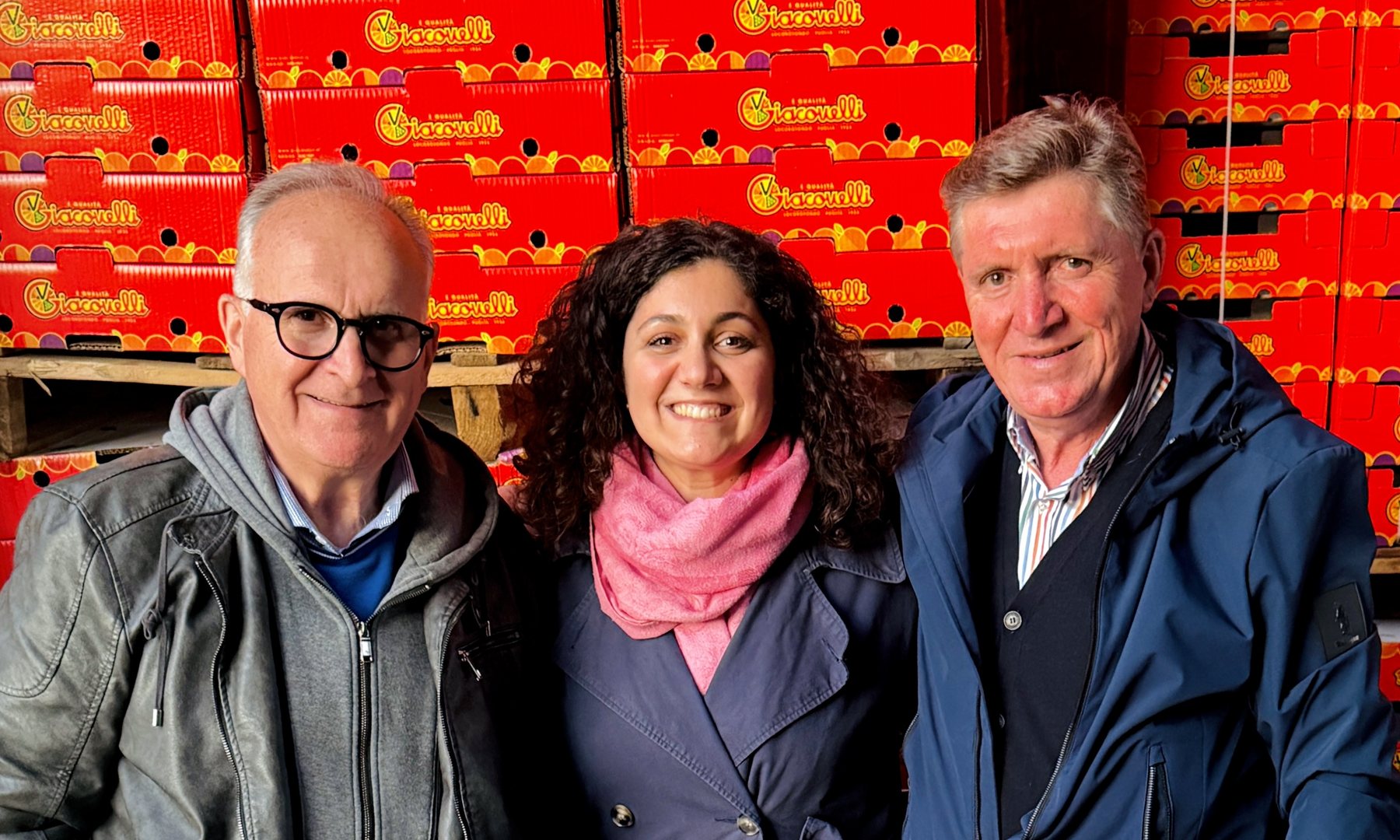 Anna Giacovelli mit ihrem Vater Raffaele und ihrem Onkel Pietro vor roten Giacovelli-Kisten im Lager