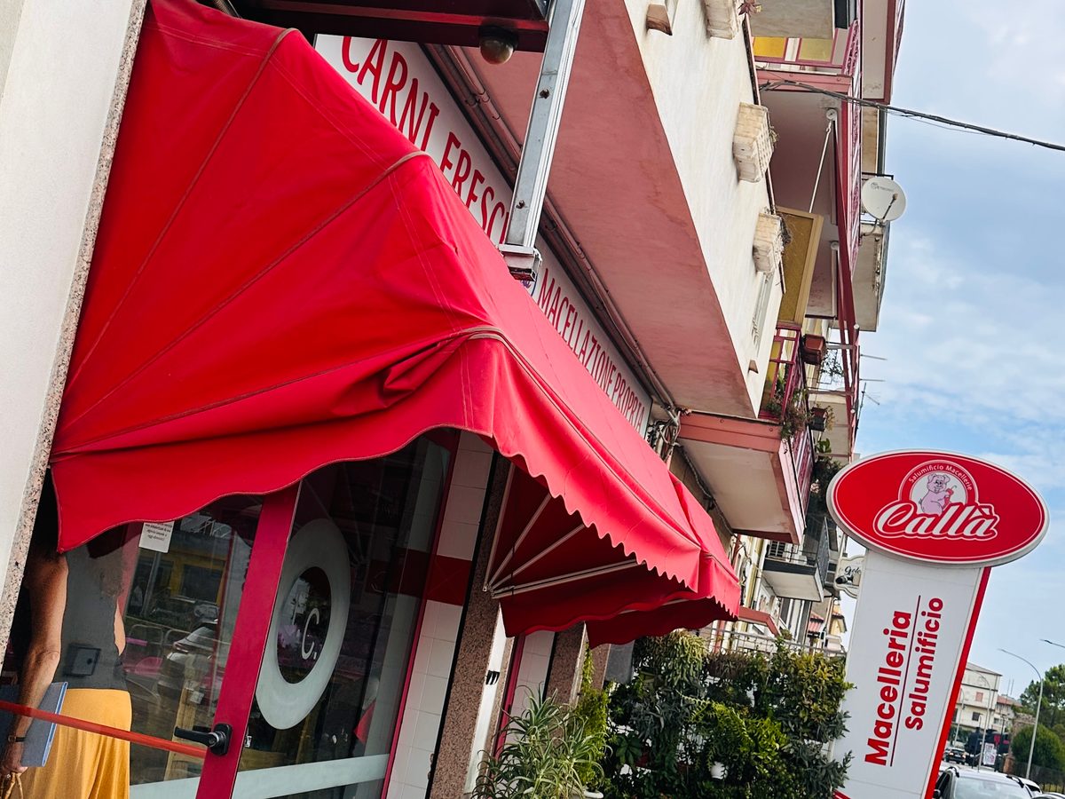 Die Metzgerei Callà in Mileto mit roter Markise und rotem Schild